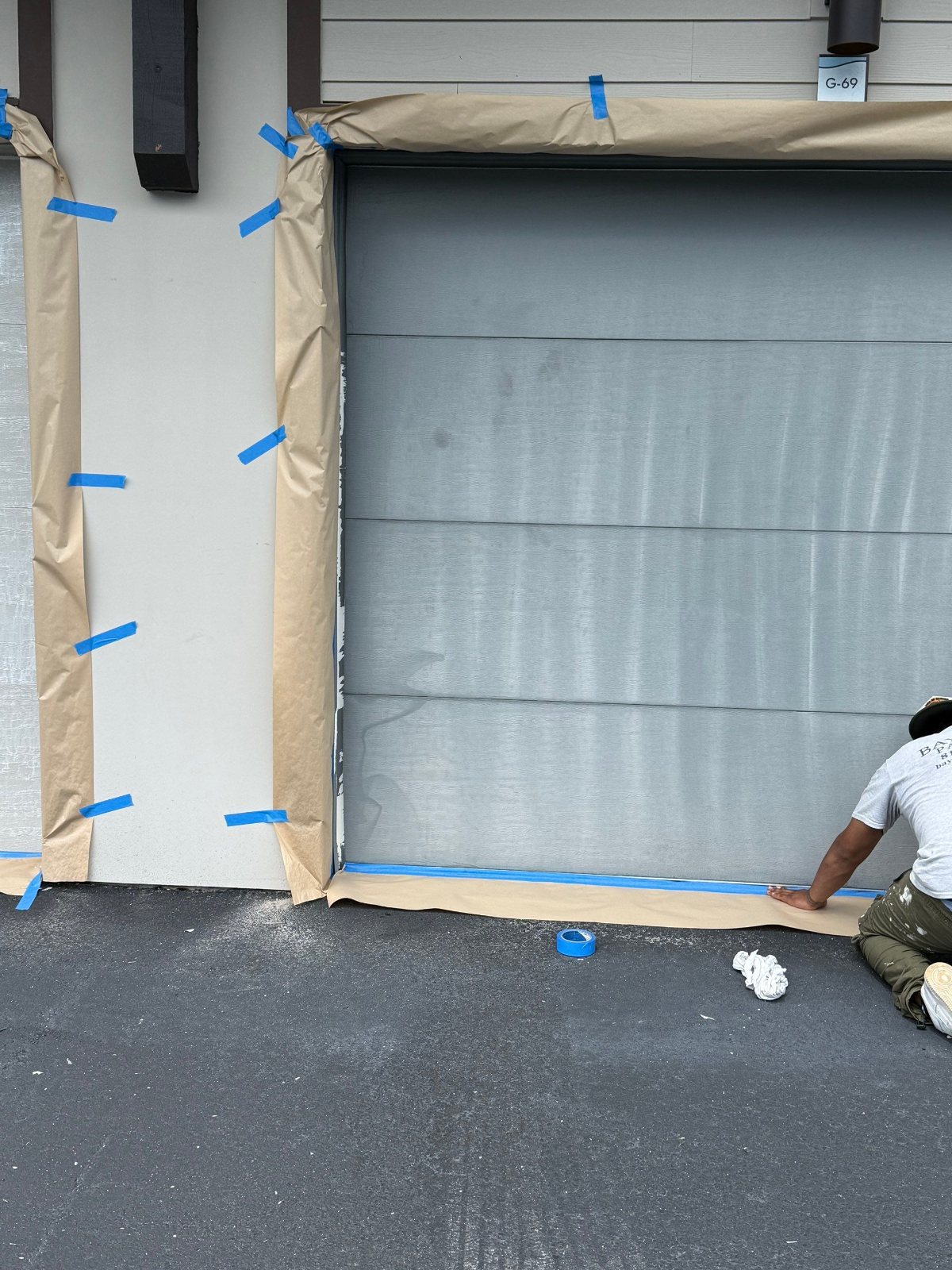 Garage door masked and prepped for painting at a Clearwater apartment community