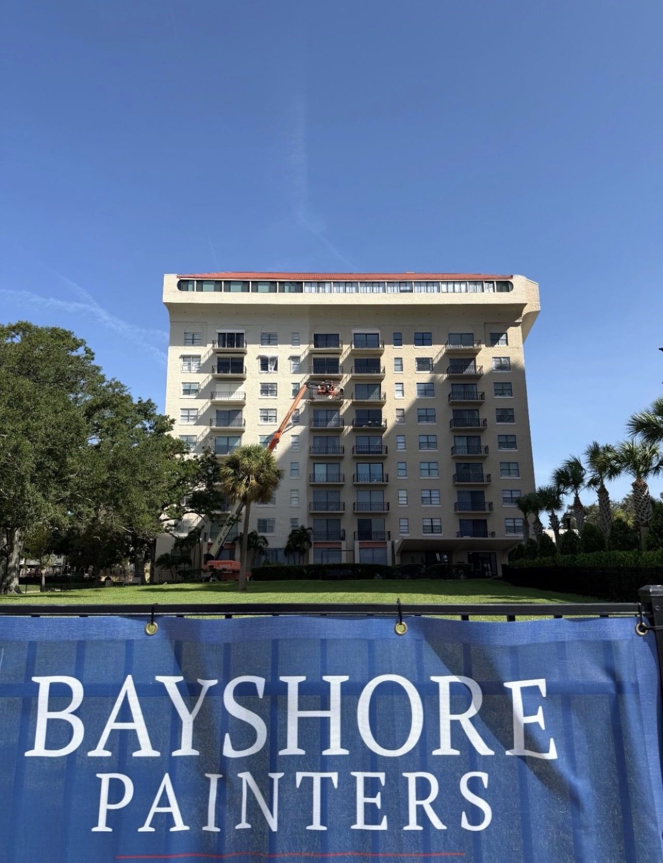 Boom lift repainting the Bayshore Royal high-rise condominium on Bayshore Blvd, Tampa