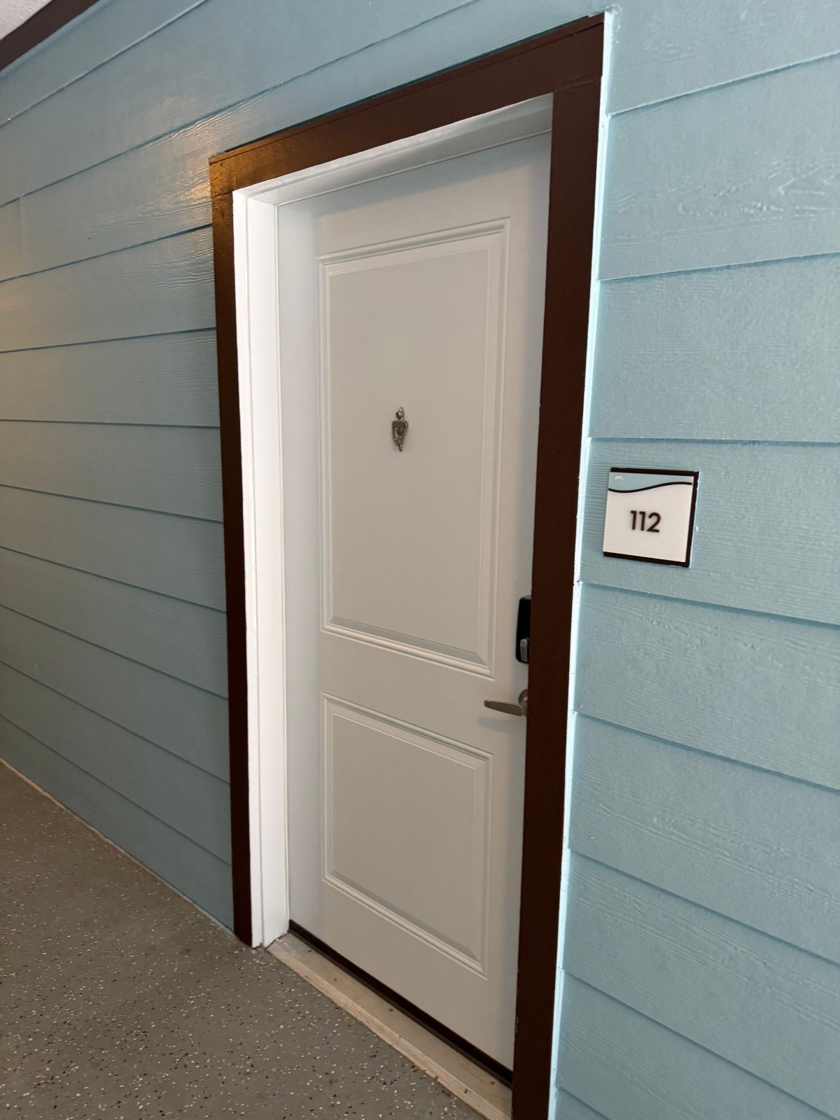 Finished breezeway siding, trim and unit door at an apartment community in Clearwater, FL