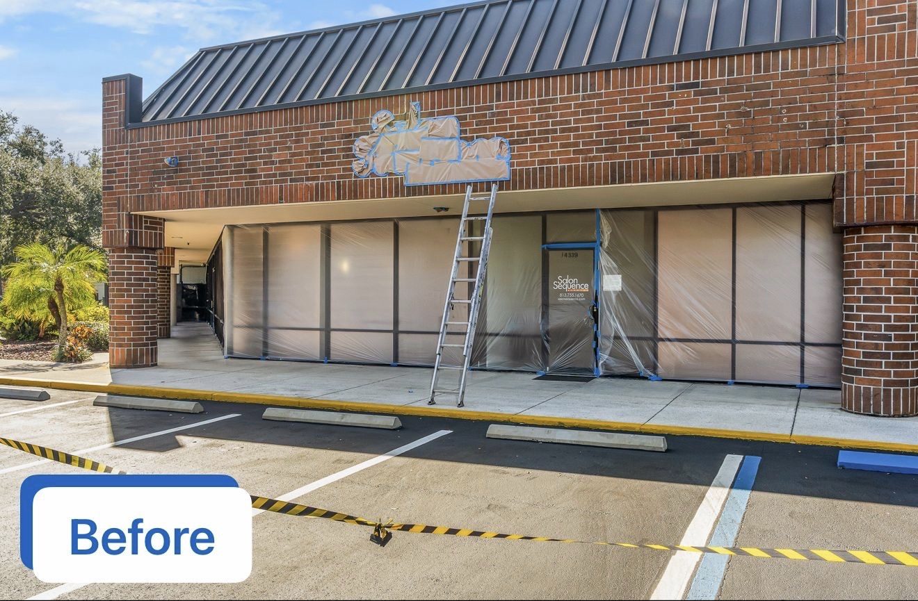 Grand Plaza Shopping Center storefront in Carrollwood masked before painting