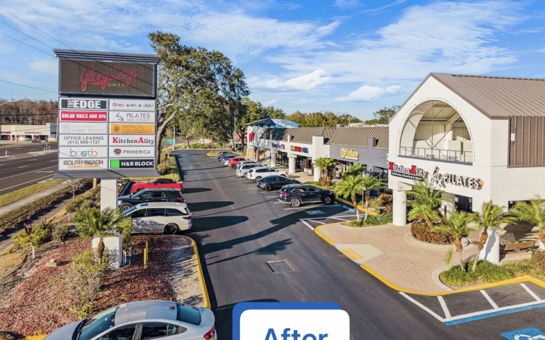 Grand Plaza Shopping Center after exterior repaint, brick painted white