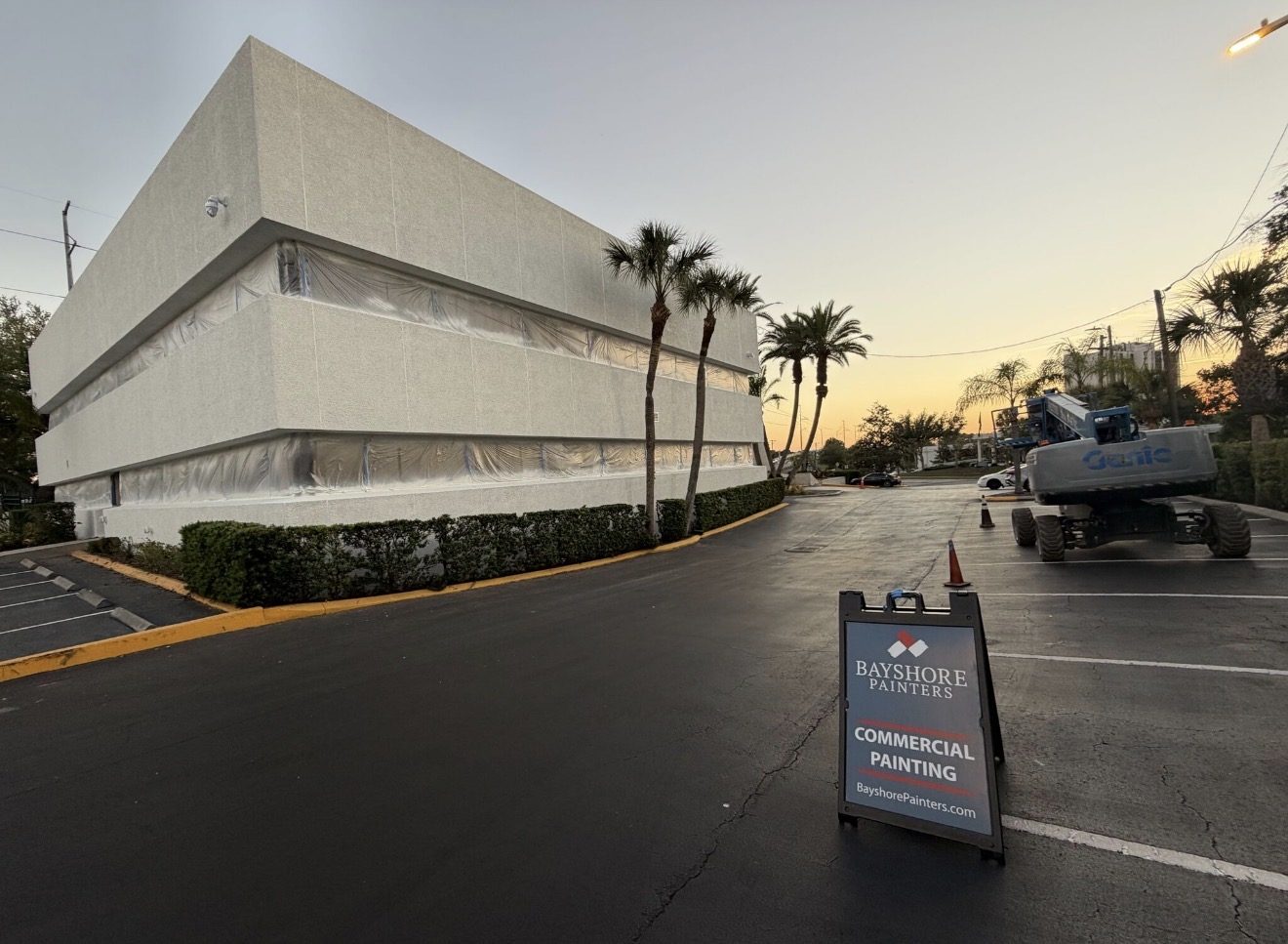 Riverside Recovery building in Tampa with Bayshore Painters sign and boom lift