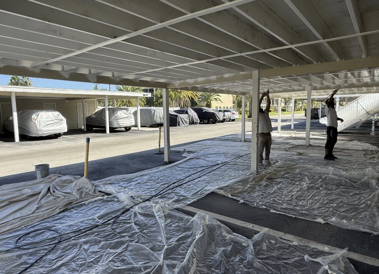 Painting carport ceilings at South Paula Point condominium in Dunedin, FL